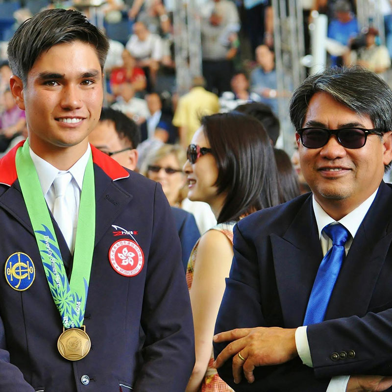 Thomas Ho (left) and his father (right) at a ‘welcome home’ event for Hong Kong atheletes in Sha Tin Racecourse after he won bronze at the Incheon 2014 Asian Games.  (Photo provided by interviewee)