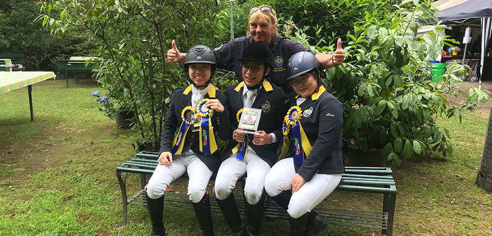 Corinne Bracken with members of the Club's Para Dressage Squad, Timothy Tsang (middle), Fleur Schrader (right) and Natasha Tse (left).  (Photo provided by interviewee)